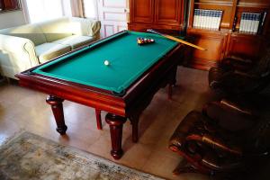 a pool table in a living room with a cue at Normand'Histoire Gite 1869 in Isigny-sur-Mer