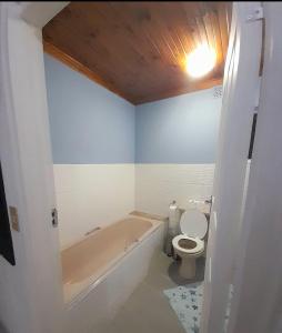 a bathroom with a bath tub and a toilet at Aqua on Newport street 1 in Port Edward +23 photos