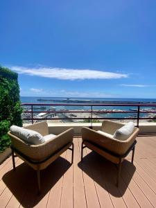two chairs on a deck with a view of the ocean at Rooftop Marina l by Madeira Best Apartments in Funchal