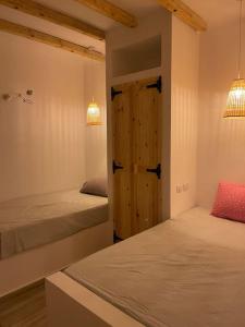 a bedroom with two beds and two lamps and a door at La hacienda Luxurious chalet with sea view garden 805 in Ras Sedr