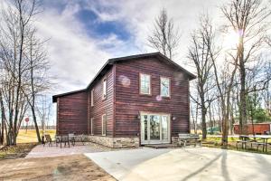 a large wooden house with a patio in front of it at Remote Retreat Cozy Home with Big Pine Lake Access! in Perham