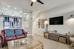 a living room with a couch and a tv at Sandpiper 95090 in Fernandina Beach