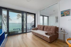 a living room with a couch and large windows at Rewal Hevenia The Best View ever in Rewal