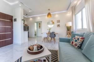 a living room with a blue couch and a table at Larimar 302 - Bayahibe in Bayahibe