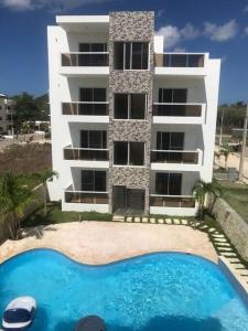 a building with a swimming pool in front of a building at Larimar 302 - Bayahibe in Bayahibe