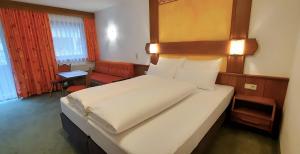 Postel nebo postele na pokoji v ubytování Hotel Garni Belvedere