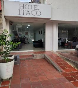 een hoteltrapo met een potplant voor een gebouw bij Hotel ITACO in Cartagena