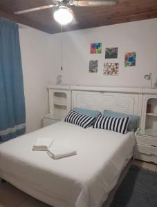 a bedroom with a large white bed with striped pillows at Aqua on Newport street 1 in Port Edward