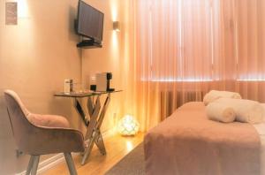 a bedroom with a bed and a table and a chair at Villa Zawaia B&B in Lagos