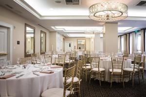 uma sala de banquetes com mesas e cadeiras e um lustre em el PRADO em Palo Alto