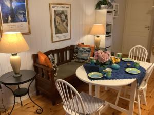 a living room with a table and a table and chairs at Torill`s Apartment in Kragerø