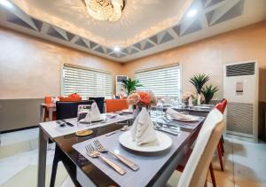 una sala da pranzo con un lungo tavolo e sedie di Medallion Hotels a Lagos