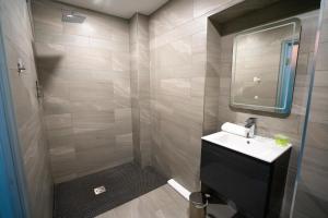 a bathroom with a sink and a mirror at Hotel 105 in Liverpool +34 photos