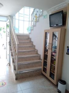 a staircase in a house with a tv on a wall at Hotel Caribe Real Inn in Santa Marta