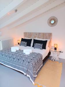 a bedroom with a large bed and two tables at Villa Zawaia B&B in Lagos