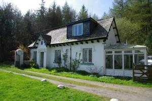 a white house with a window on top of it at Bar Hill Lodge in Gatehouse of Fleet