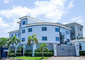 a blue building with palm trees in front of it at Medallion Hotels in Lagos