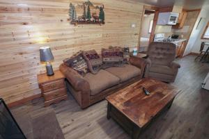 a living room with a couch and a table at Ponderosa Lodge in Estes Park