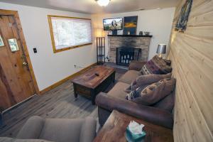 a living room with a couch and a fireplace at Ponderosa Lodge in Estes Park