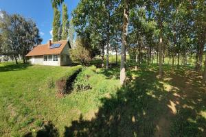 a house in the middle of a field with trees at Kućerak Višnja in Manđelos