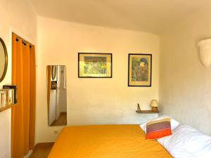 a bedroom with a bed and two pictures on the wall at Palombaggia in Porto-Vecchio