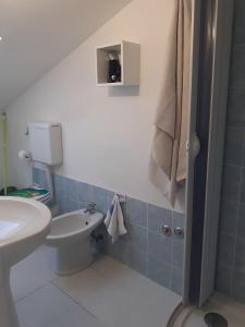 a small bathroom with a sink and a toilet at La Casa di Berenice a Porto Azzurro in Porto Azzurro