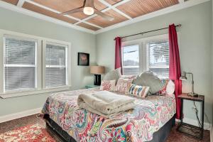 a bedroom with a bed and two windows at Palmettos Cabana in Saint Augustine