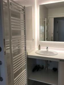 bagno bianco con lavandino e specchio di Albatros (wifi y garaje) ad Ávila