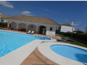 a large swimming pool in front of a house at Arcos Garden campo de golf fairway in Vallejas