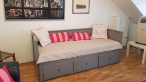 a bed with two pillows on it in a room at LUNA City Apartman in Sopron