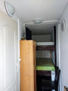 a small room with a bunk bed and a door at Back Garden Cabin Home with Terrace(Self Check-in) 
