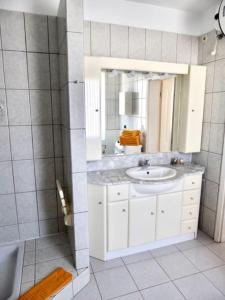 a bathroom with a sink and a mirror at Dein Appartement Sunset View und Meer in La Pared