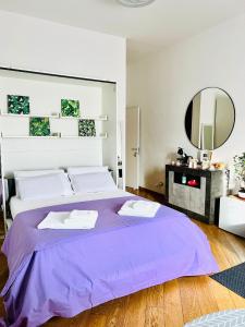 a bedroom with a large purple bed and a mirror at Residenza San Niccolò in Florence