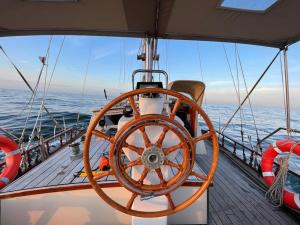 a large wooden wheel on the deck of a boat at Classic sailing ship in center of Enkhuizen! in Enkhuizen
