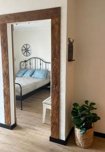 a mirror in a bedroom with a bed in a room at Sea & Home in Gąski