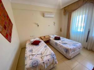 A bed or beds in a room at Yalcin Hotel & Villas