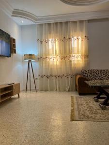 a living room with a couch and a curtain at Djerba Dar BAYA in Houmt Souk