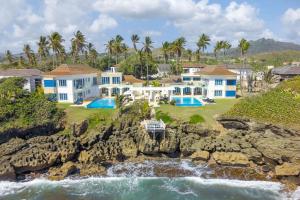 an aerial view of a house on the rocks next to the ocean at Peninsula Esmeralda Luxury Hotel & Villas in San Felipe de Puerto Plata