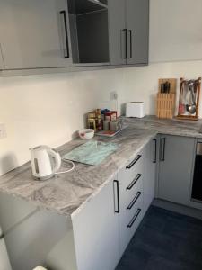 a kitchen with a marble counter top in a kitchen at Worthing bright and cosy double room in Worthing