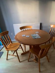 a wooden table with two chairs and a wooden table and chairsktop at Worthing bright and cosy double room in Worthing