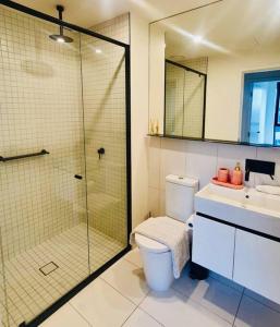 a bathroom with a shower and a toilet and a sink at High Rise Unit in front of Crown with Free Parking in Melbourne