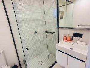 a bathroom with a glass shower and a sink at High Rise Unit in front of Crown with Free Parking in Melbourne