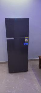 a black refrigerator is sitting in a room at new ikea flat 1 in Hurghada