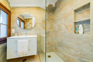a bathroom with a shower and a sink and a mirror at Casa Remotti in Antequera +26 photos