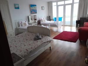 a bedroom with two beds and a red rug at Beach lodge Stunning Sea Views in Portballintrae