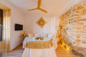 a living room with a table and a stone wall at Casa Remotti in Antequera