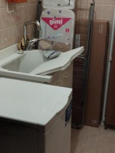 a kitchen with a sink and a counter top at Appartamento due camere Castellarano Sassuolo in Castellarano +9 photos