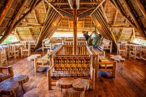 a large room with tables and chairs in a building at Elite Backpackers Services in Masaka