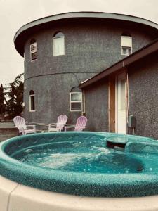 a hot tub in front of a building at Lavender Castle in Sequim