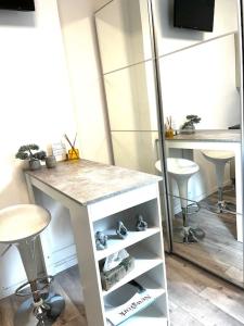 a kitchen with a counter and stools in a room at Útulný byt v historickom centre Bratislavy in Bratislava